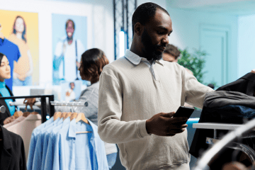 Image of a man looking though a clothing rack for a blog post covering how to become a mystery shopper.