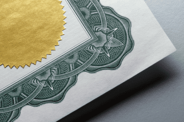 Image of the corner of a certificate over a gray background for a blog post asking "is MSPA certification worth it?"