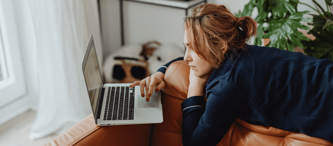 Image of a woman on a couch for a post asking the question "is mystery shopping legit?"