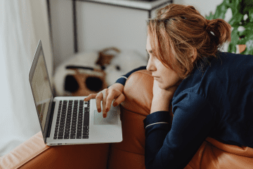 Image of a woman on a couch for a post asking the question "is mystery shopping legit?"