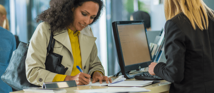 Image of a woman making a deposit at a bank for an article covering bank mystery shopping.