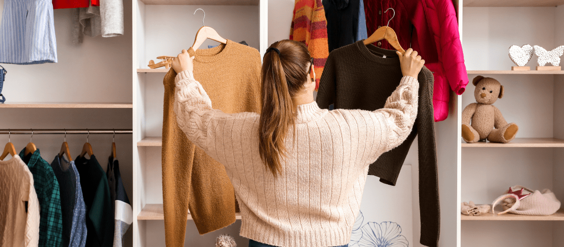 Image of a woman in a store comparing two sweaters for a post on how mystery shopping companies work.