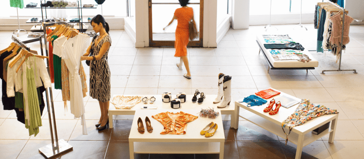 Image of a woman shopping in a high-end clothing store for an article covering mystery shopping full time.