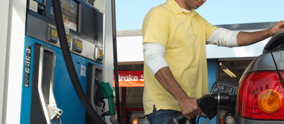 Image of a man pumping gas for his car for a blog post discussing mystery shopping mileage.