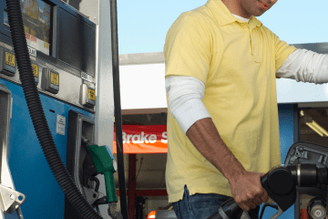 Image of a man pumping gas for his car for a blog post discussing mystery shopping mileage.