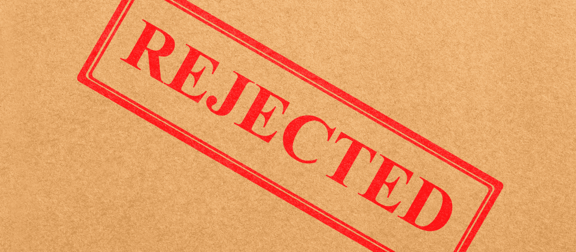 Image of a "Rejected" stamp on a cardboard background for a blog post discussing mystery shopping rejections.