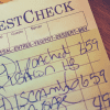 Image of a restaurant check on a table for a blog post covering restaurant mystery shopping.