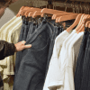 Image of a man looking at clothes in a store for a post about retail mystery shopping.