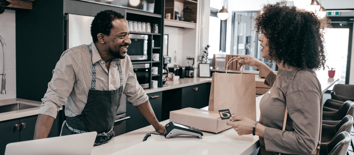 Image of a woman checking out during a shop for an article answering the question "what is mystery shipping?"