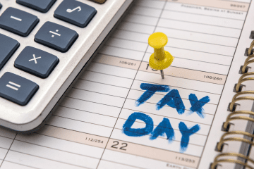 Image of a calculator and a calender marked "tax day" for a blog post covering the best tax software for mystery shoppers.