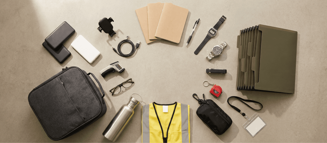 Image of a mystery shopper carry kit laid out in a flat-lay arrangement, including a portable charger, car phone mount, notebooks, pens, two Casio watches, a file folder, EDC pouch, insulated lunch bag, water bottle, safety vest, infrared thermometer, reading glasses, keychain tape measure, and ID badge holder on a neutral beige surface.