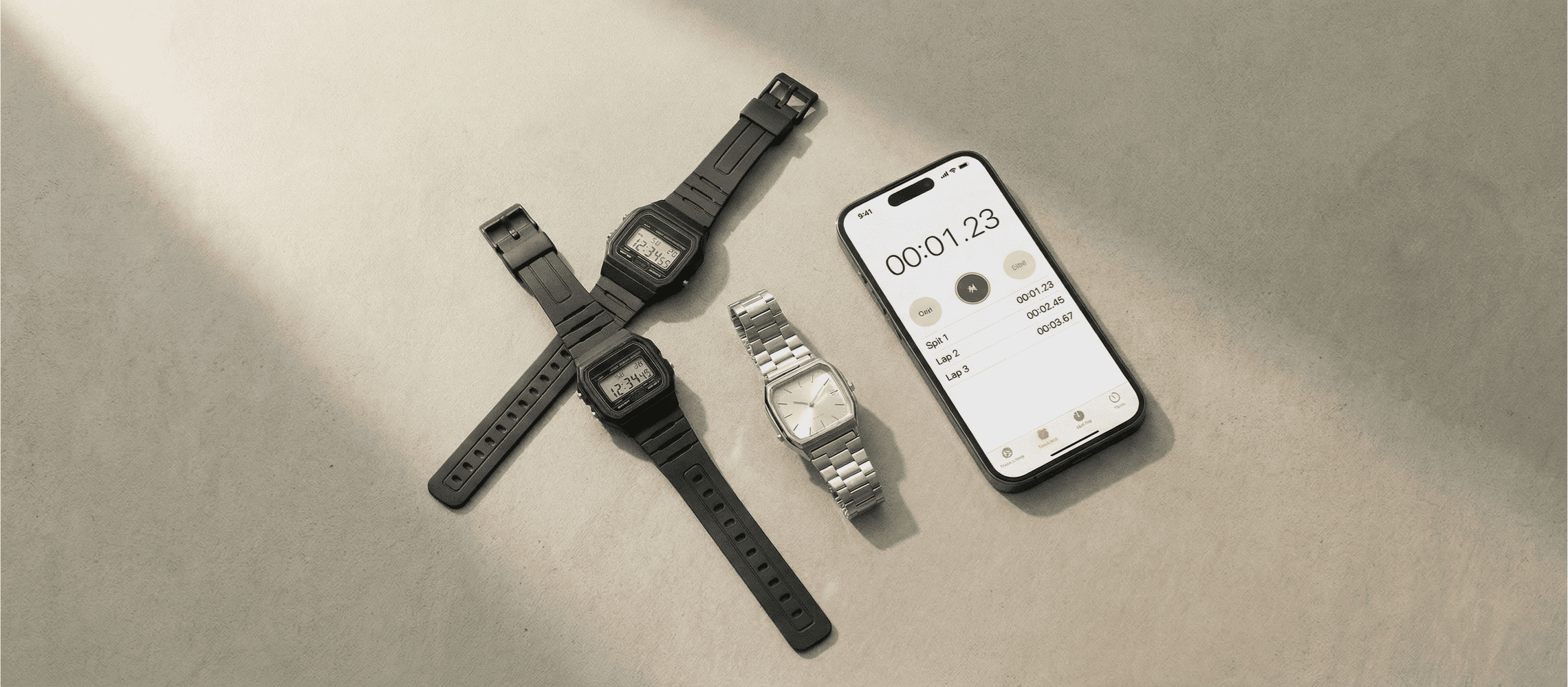 Image of mystery shopper carry kit timekeeping tools including a Casio digital watch, analog watch, and smartphone displayed on a neutral surface