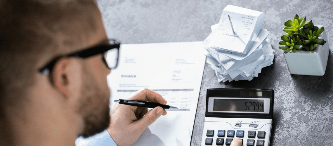 Image of a man working at a desk for an article discussing mystery shopping expense tracking.