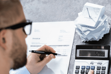 Image of a man working at a desk for an article discussing mystery shopping expense tracking.