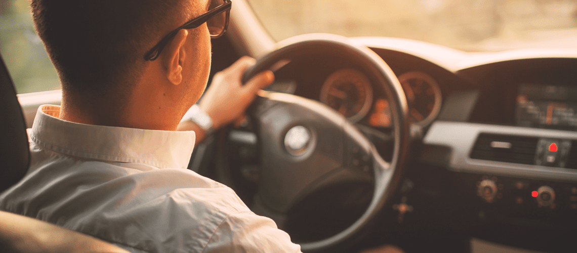Image of a man driving in his car for an article covering mystery shopping mileage tracking.