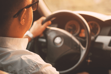 Image of a man driving in his car for an article covering mystery shopping mileage tracking.