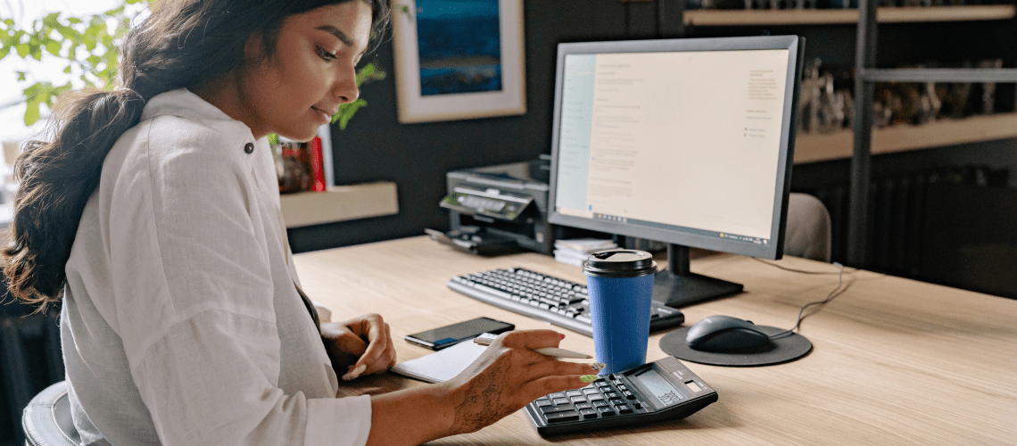 Image of a woman working in her home office for a blog post covering mystery shopping self-employment tax.